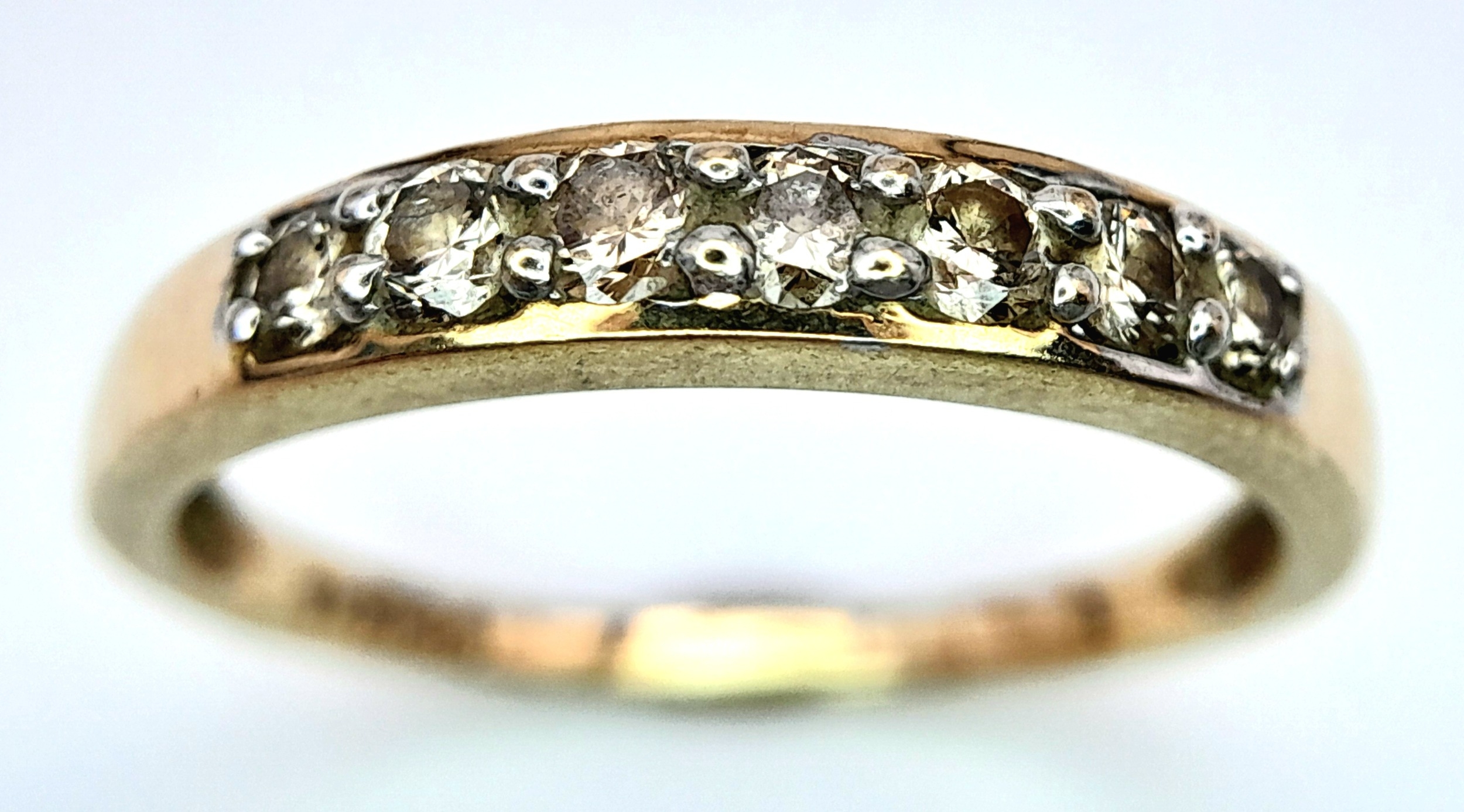 A 9K YELLOW GOLD DIAMOND SET BAND RING. 0.25ctw, Size N, 1.8g total weight. Ref: SC 8007