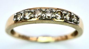 A 9K YELLOW GOLD DIAMOND SET BAND RING. 0.25ctw, Size N, 1.8g total weight. Ref: SC 8007