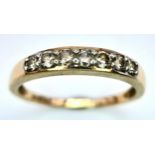 A 9K YELLOW GOLD DIAMOND SET BAND RING. 0.25ctw, Size N, 1.8g total weight. Ref: SC 8007