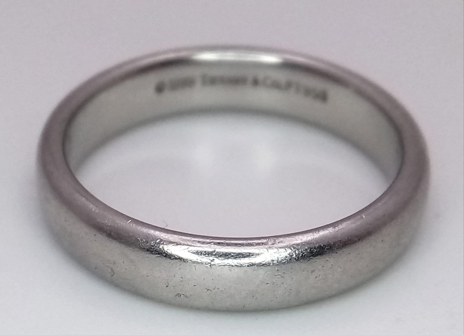 A Tiffany and Co Platinum 4mm rounded band ring. 9.3g. Size Q. - Image 3 of 4