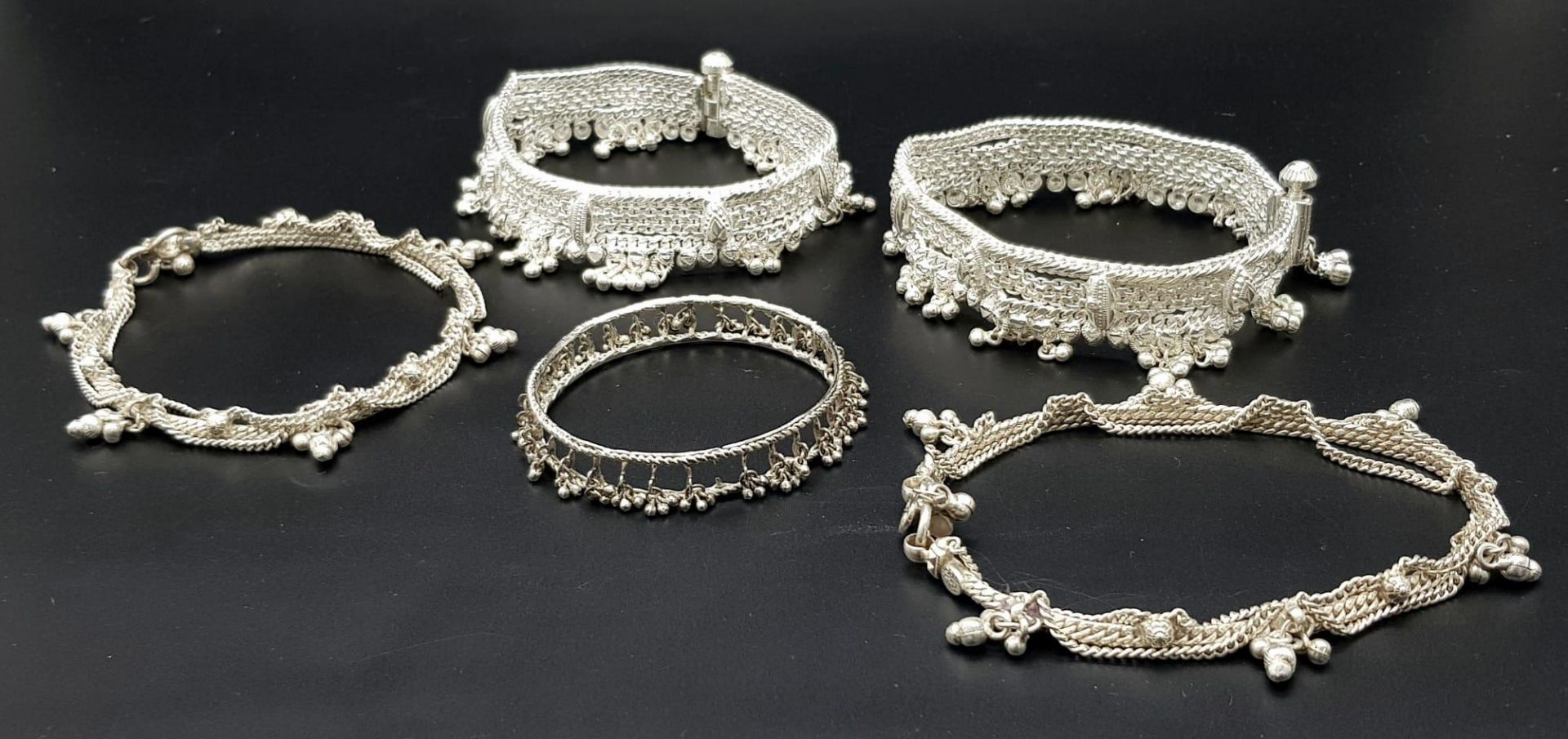 A Vintage Indian Silver (800) Jewellery Collection. Includes 4 upper arm decorative bands and one