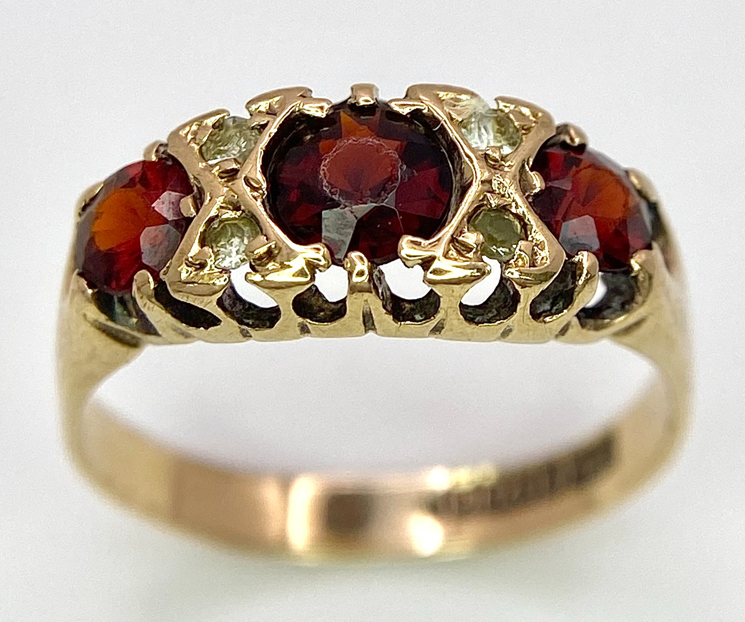 A 9K Yellow Gold, Garnet and Diamond Ring. Size K, 1.9g total weight. Comes in presentation case.