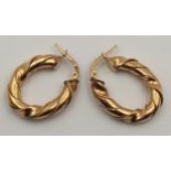 A 9 K yellow gold pair of hoop earrings with a twisted design, drop: 26 mm, total weight: 5 g.