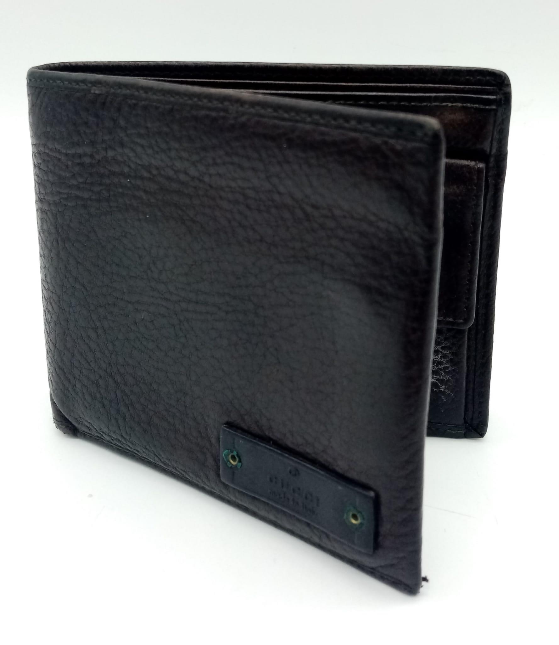 A dark brown leather Gucci card wallet, 3 card holders with a popper pocket. Size approx.