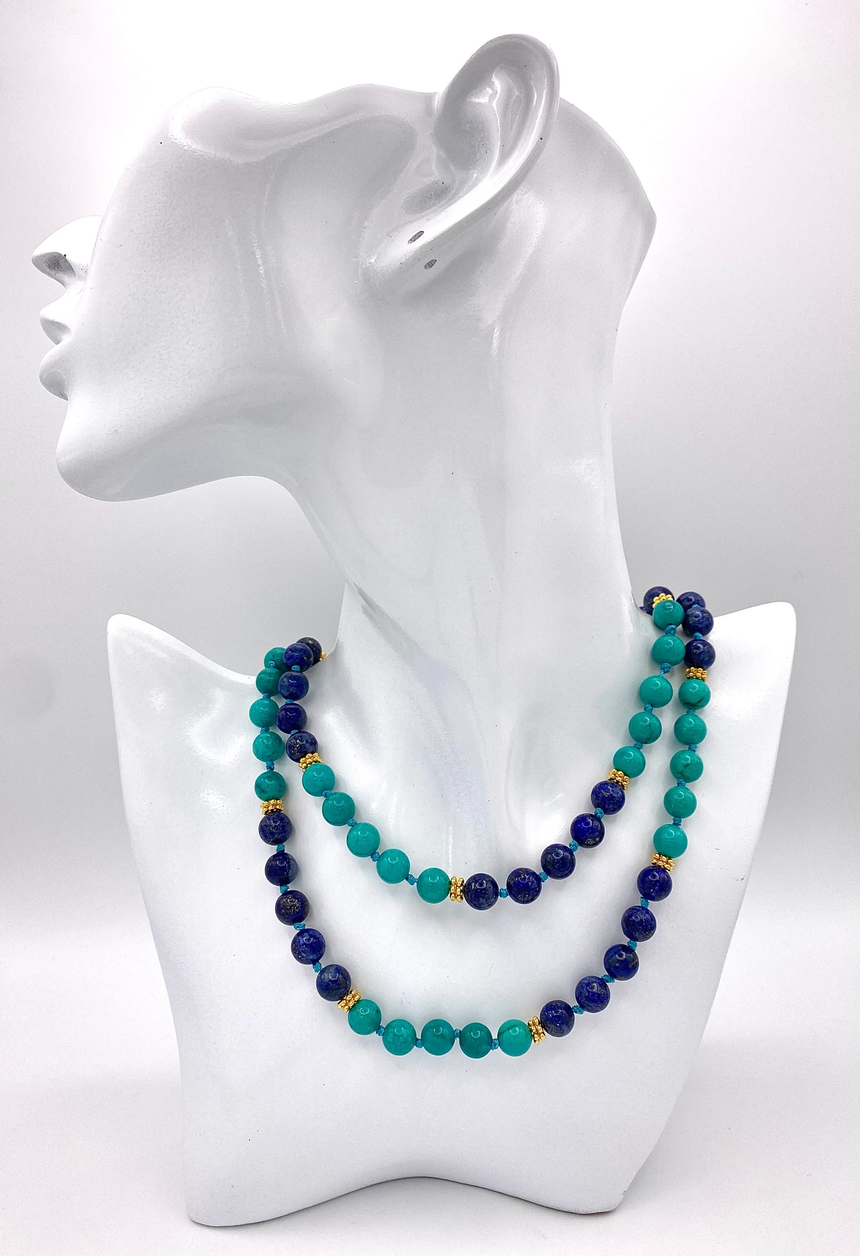 A Lapis Lazuli and Turquoise Matinee Length Beaded Necklace. 94cm length. Gilded spacers and