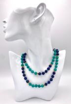 A Lapis Lazuli and Turquoise Matinee Length Beaded Necklace. 94cm length. Gilded spacers and