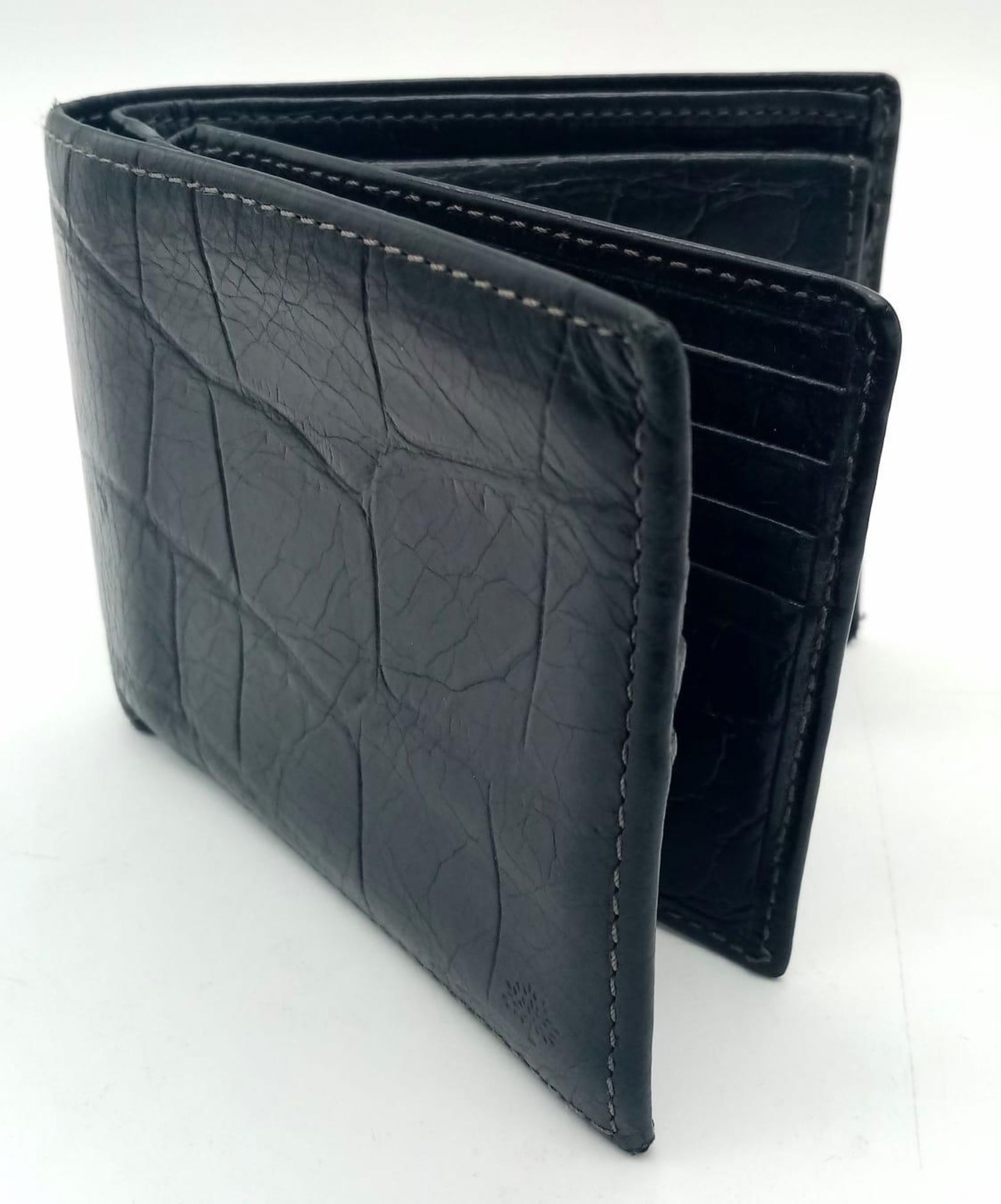 A black leather Mulberry wallet, can hold up to 8 cards, includes a coin pouch. Size approx. 11x9cm.