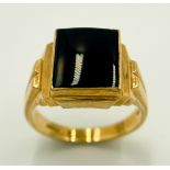 A 9 K yellow gold cygnet ring with a black rectangular onyx cabochon and grooved shoulders. Size: U,
