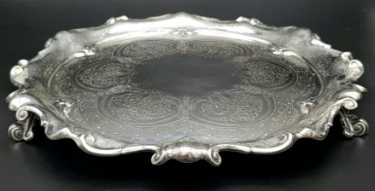 A 761gms solid silver Salva with scrolled edges and hand chased intricate decoration and