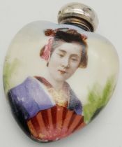 An Antique Decorative Geisha Girl Porcelain Scent Bottle in a Heart Shape. Sterling silver top -