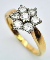 An 18K Yellow Gold Diamond Ring. Seven diamonds in a floral shape - 0.7ctw. Size O. 4.2g total