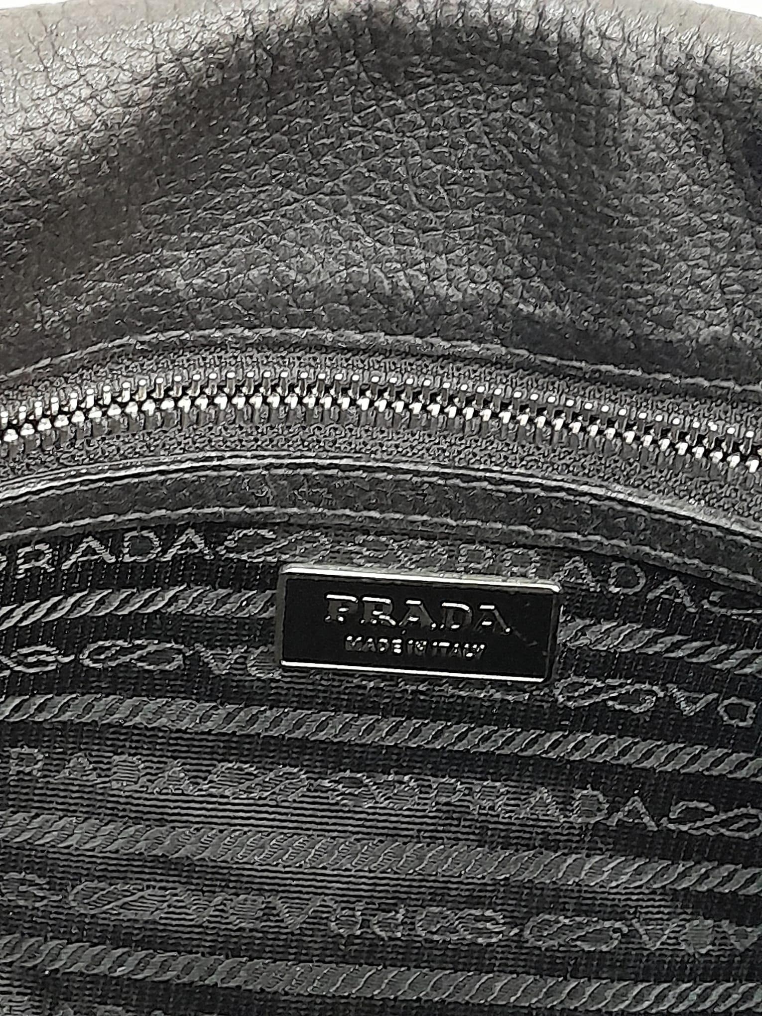 A Prada Black Shoulder Bag. Leather exterior with silver-toned hardware, two rolled leather - Image 6 of 7
