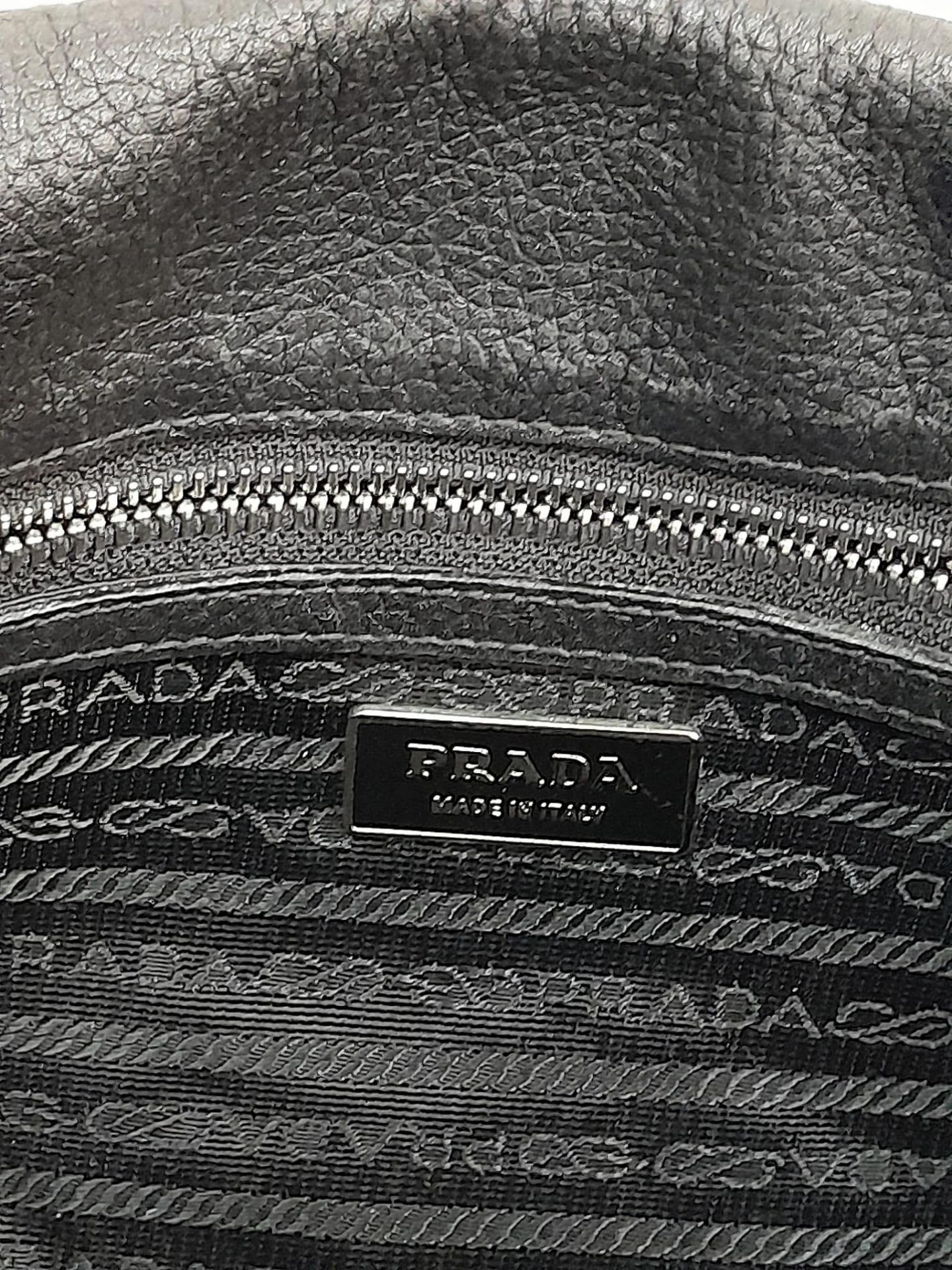 A Prada Black Shoulder Bag. Leather exterior with silver-toned hardware, two rolled leather - Bild 6 aus 7
