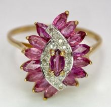 A 9K YELLOW GOLD DIAMOND AND RUBY FANCY SPIRAL CLUSTER RING. 3G. SIZE U.