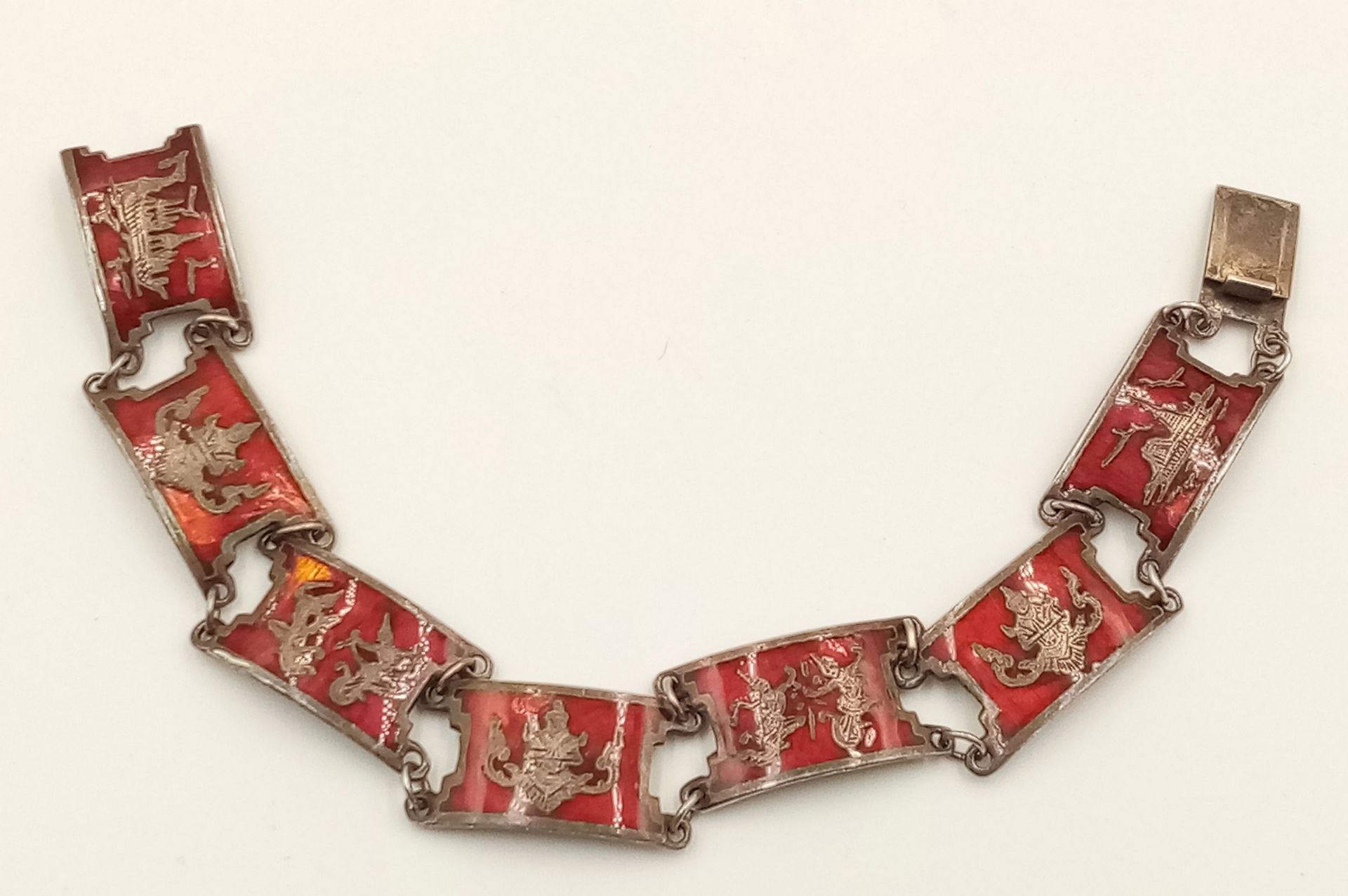 A STERLING SILVER INDIAN RED ENAMELLED BRACELET -FEATURING VARIOUS GODS. 20.3G - Image 2 of 4