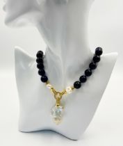 A Vibrant Amethyst Bead Necklace with a Hanging Keisha Baroque Pearl Pendant. 12mm amethyst beads.