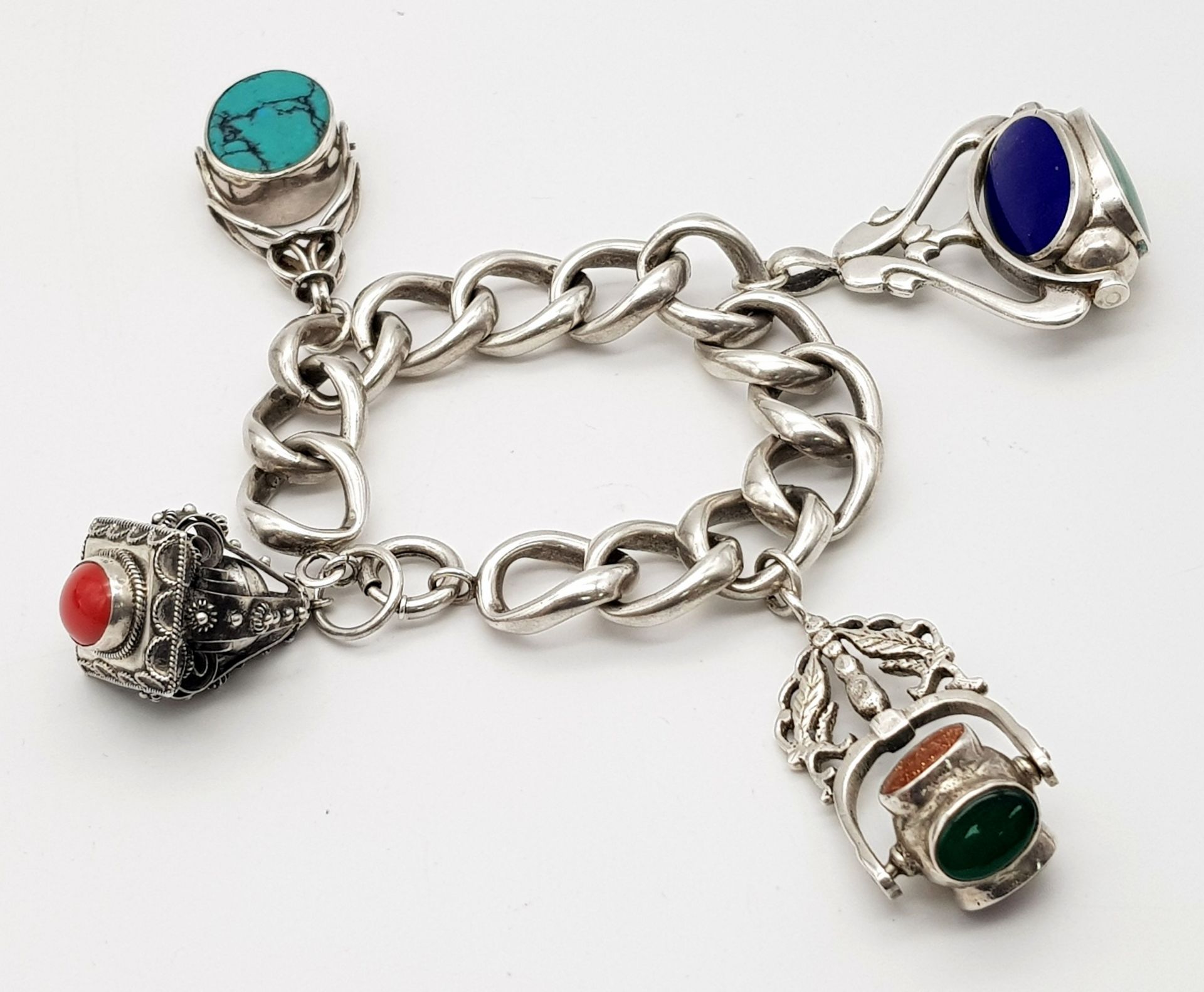 AN UNUSUAL SILVER CHARM BRACELET WITH LARGE STONE SET CHARMS (SEE PHOTO) 90.6gms