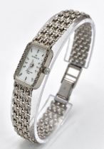 A 9K White Gold Sovereign Quartz Watch. 9K gold bracelet and case - 13mm. White dial. Diamond bezel.