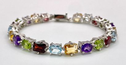 A Multi-Gemstone Bracelet consisting of: Peridots, Amethysts, Blue topaz, Garnet Citrine & Rubies.