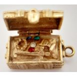 A 9K YELLOW GOLD TREASURE CHEST CHARM, WHICH OPENS TO REVEAL THE TREASURE INSIDE. 2cm length, 6.5g