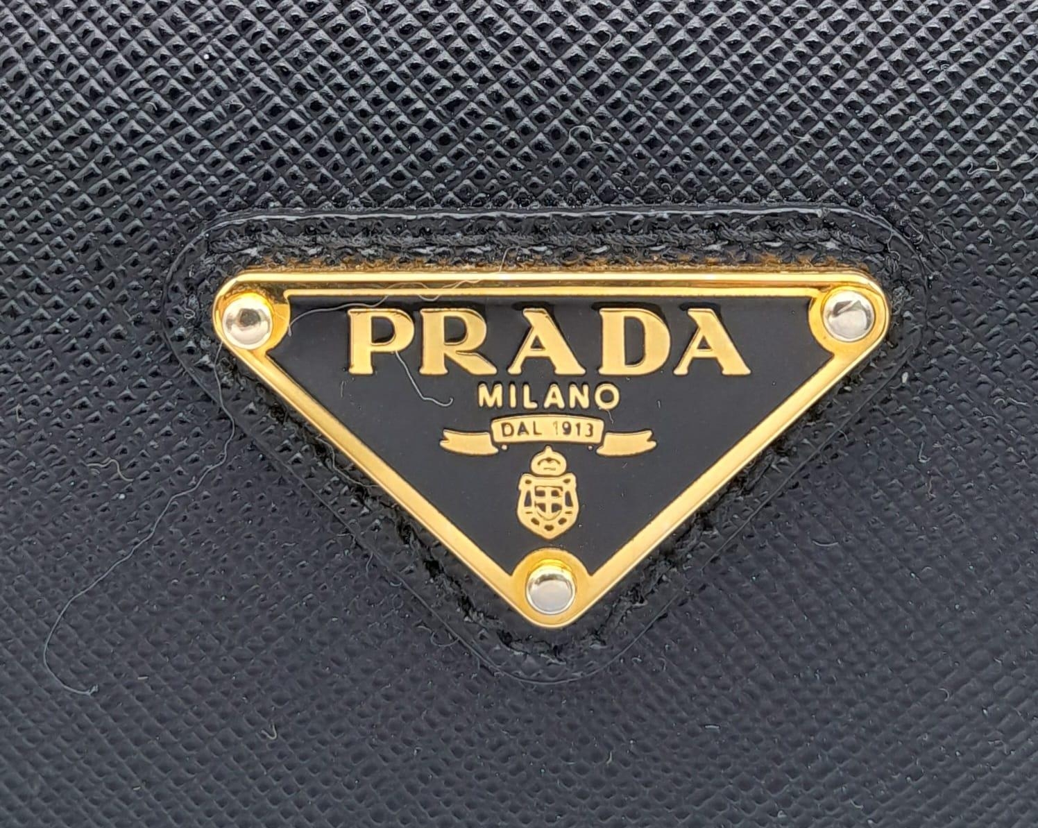 A Prada Black Bauletto Handbag. Saffiano leather exterior with gold-toned hardware, padlock, 2 - Image 11 of 11