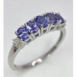 A Tanzanite and Diamond Ring. Set in 925 silver. Size O.