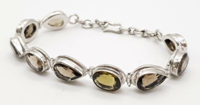 A Silver Smoky Quartz Tennis Bracelet. Set in 925 Sterling silver. 39ctw. W- 19.4g. Ref: HV2242