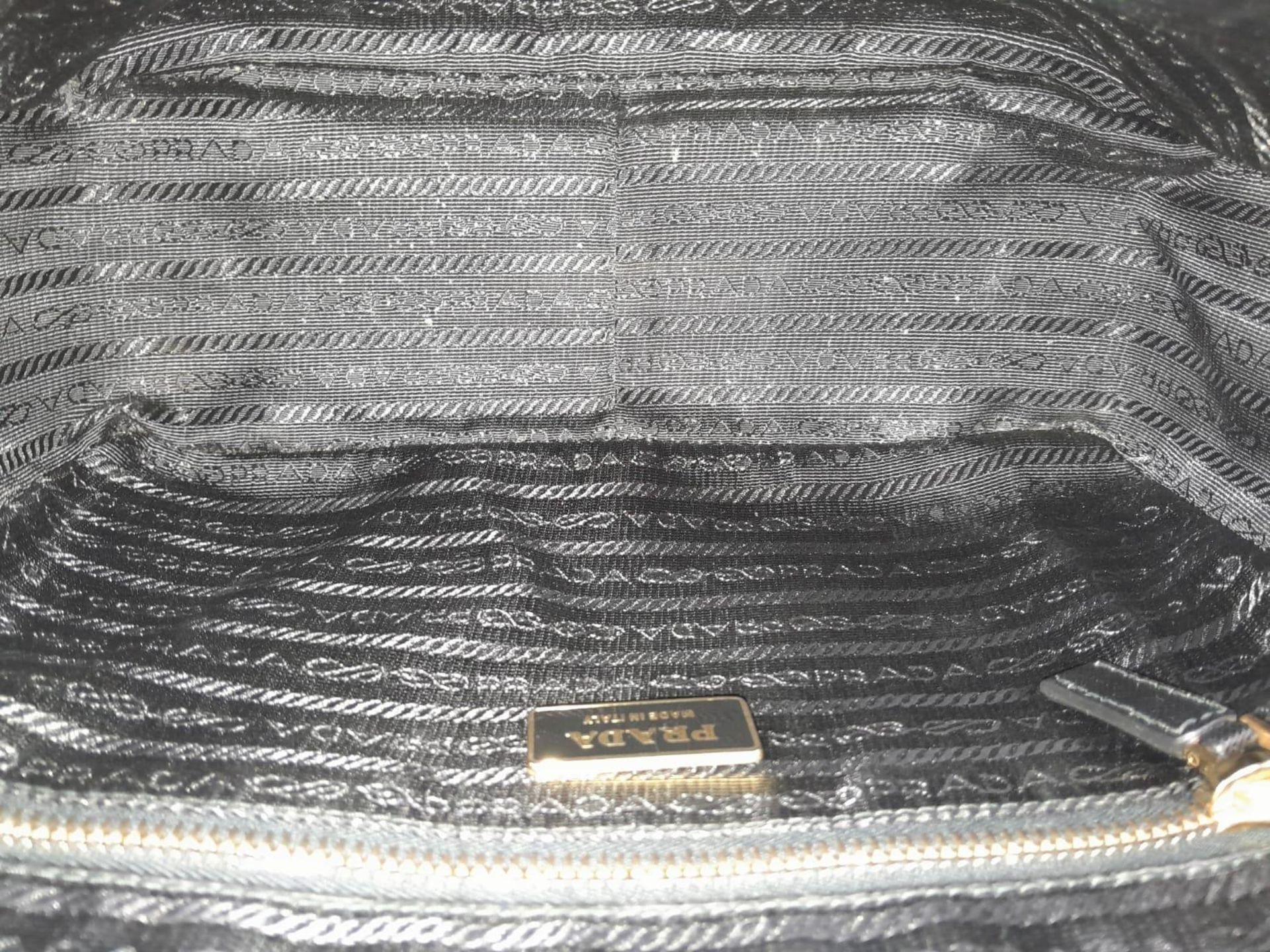 A Prada Black Bauletto Handbag. Saffiano leather exterior with gold-toned hardware, padlock, 2 - Image 7 of 11