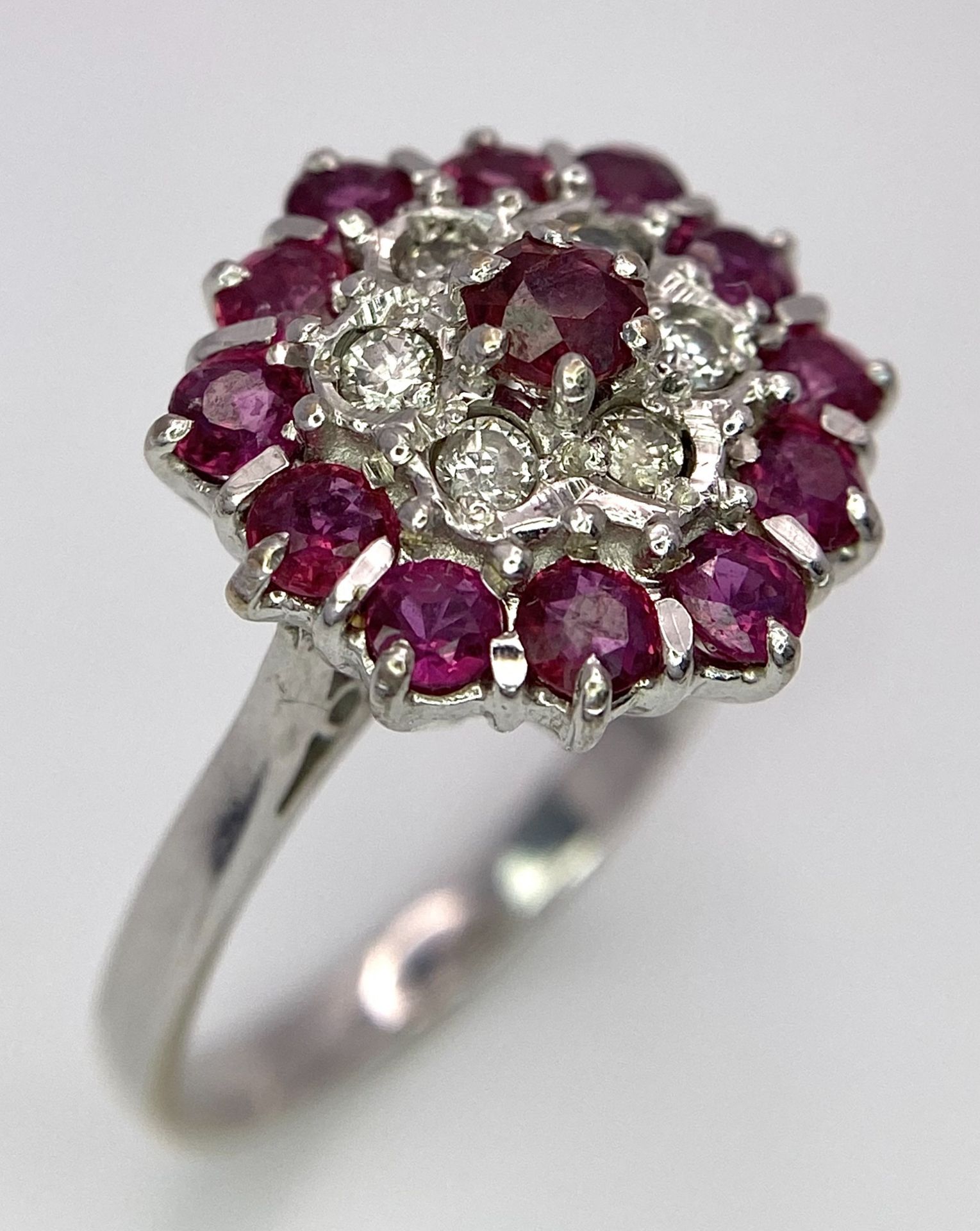 A Gorgeous 18K White Gold, Ruby and Diamond Ring. Floral design on an elevated setting. 14 rubies - Image 2 of 6