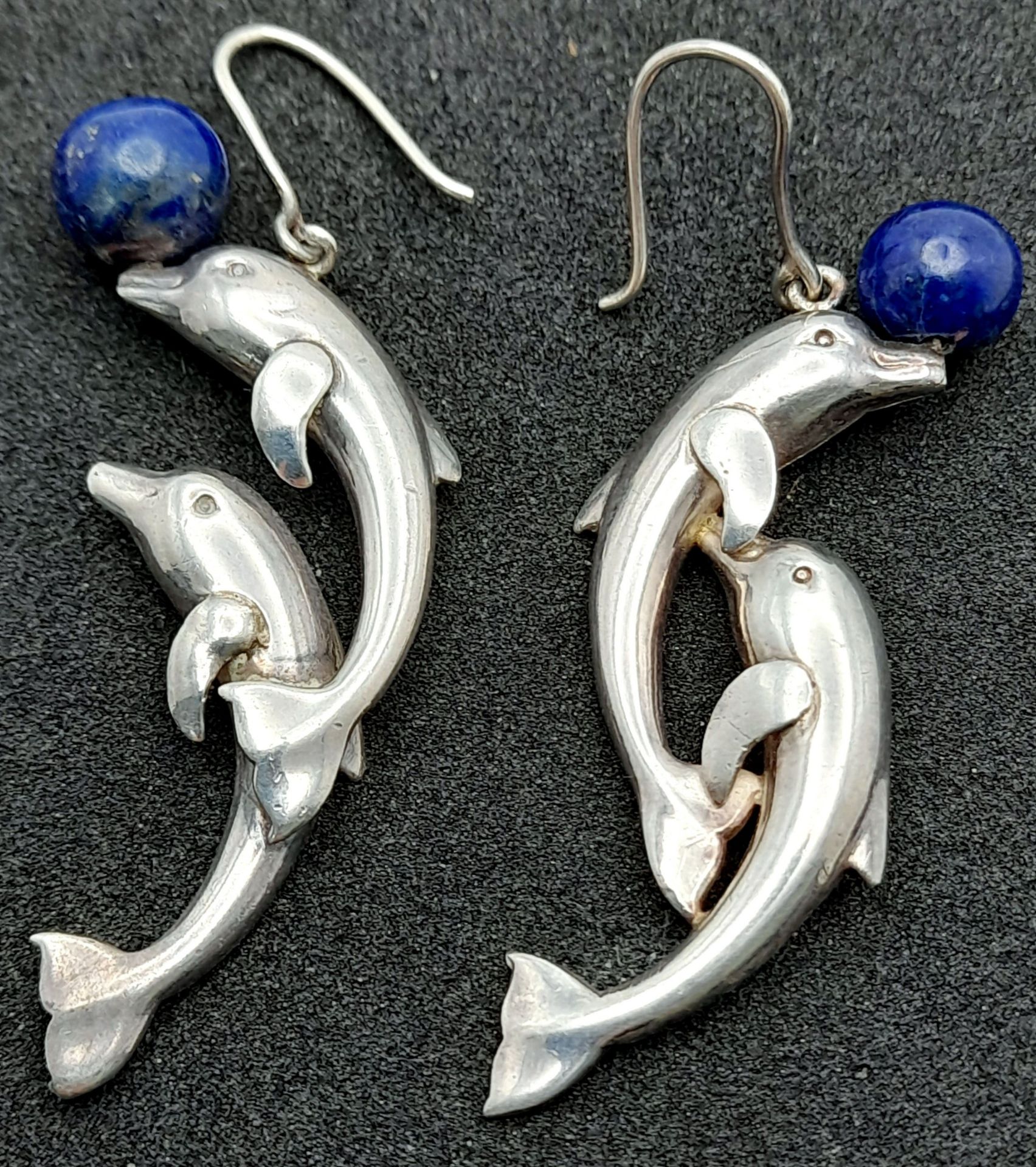 A Pair of Sterling Silver Lapis Lazuli Leaping Dolphin Earrings. 5.5cm Length.