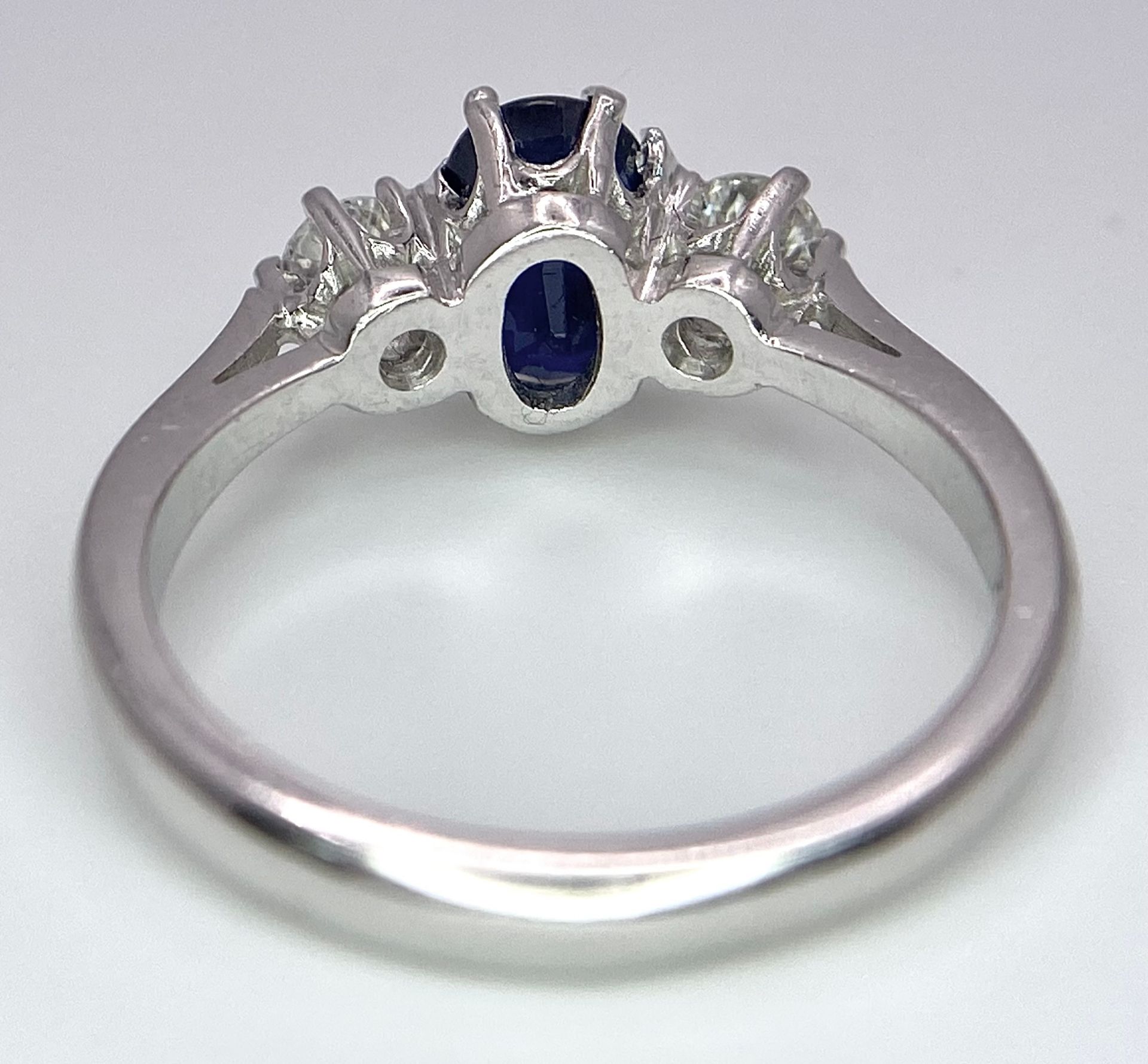AN 18K WHITE GOLD, DIAMOND AND SAPPHIRE 3 STONE RING. OVAL BLUE SAPPHIRE - 0.75CT AND 0.30CT OF - Image 5 of 6