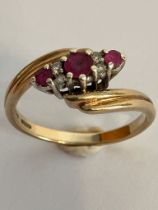 Beautiful 9 carat GOLD, RUBY and DIAMOND RING. Fabulous double crossover style. Please see