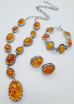 An Amber Resin Cabochon Jewellery Suite: A pair of earrings, bracelet and necklace - 56cm.