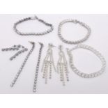 A White metal rhinestone costume bundle including 3x bracelets (all 19cm) and 3 pairs of earrings.