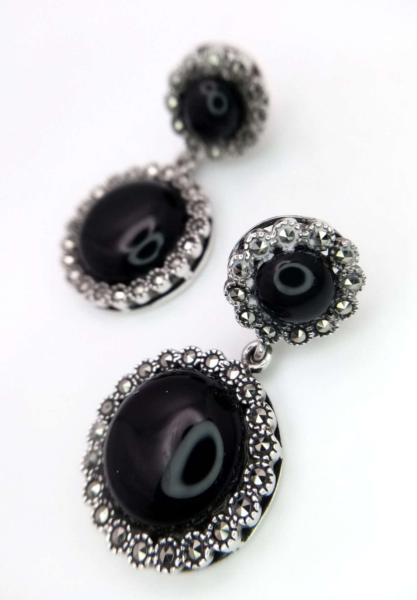 A Pair of 925 Silver, Black Onyx and Marcasite Drop Earrings. 3cm drop. Comes with a presentation