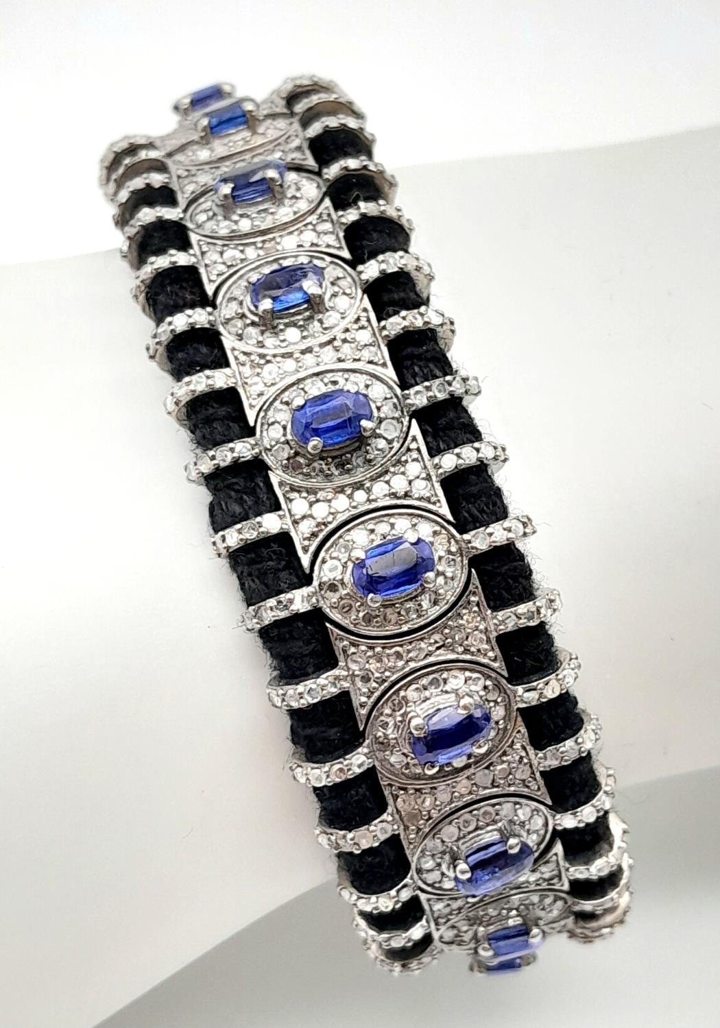 A Hand-Crafted Blue Sapphire and Diamond Encrusted Bracelet. Black textile set. Sapphires - 5ctw.