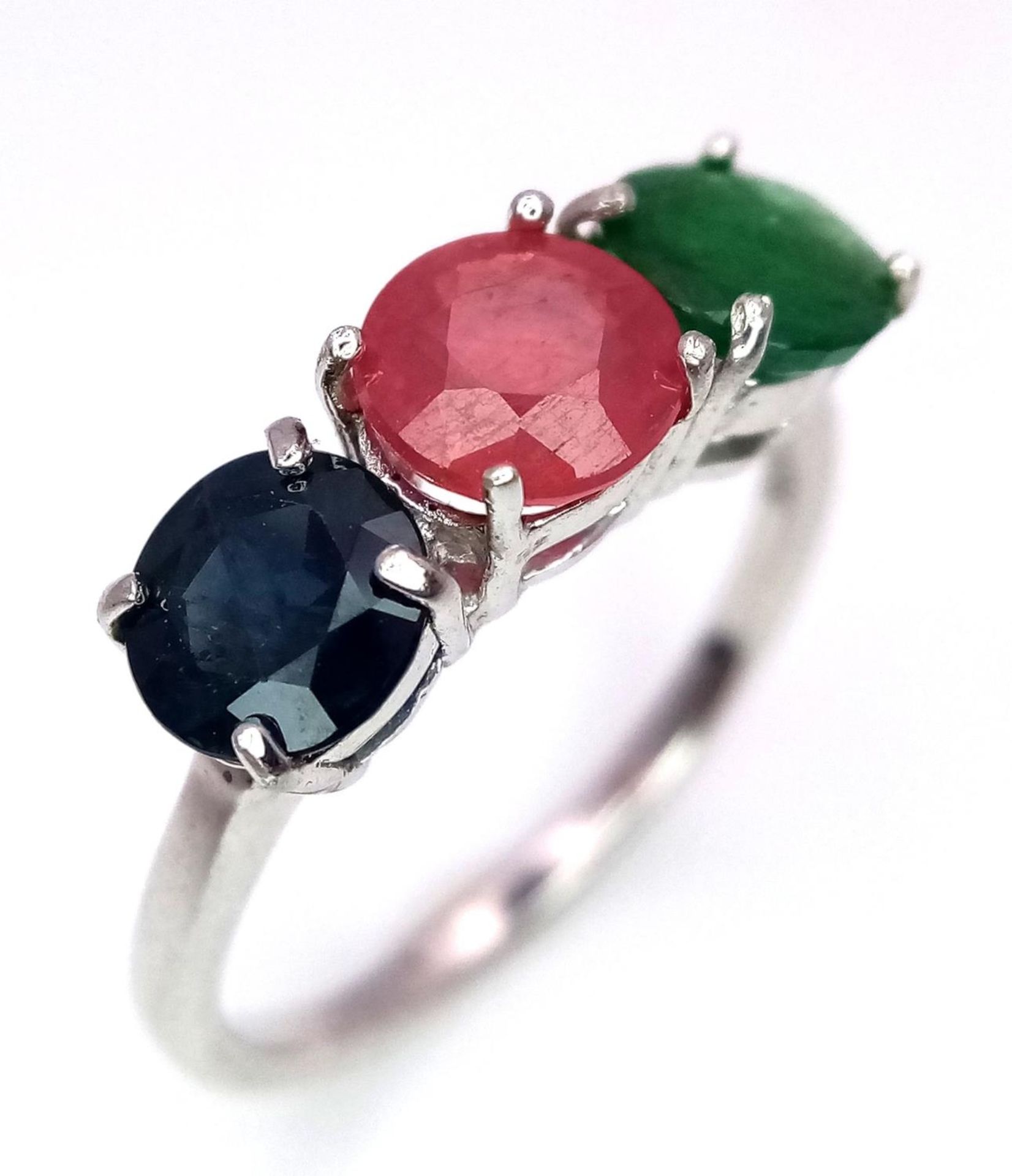 An Emerald, Sapphire and Ruby Three Stone Ring on 925 Silver. Size N1/2, 2.4g total weight. - Image 3 of 5