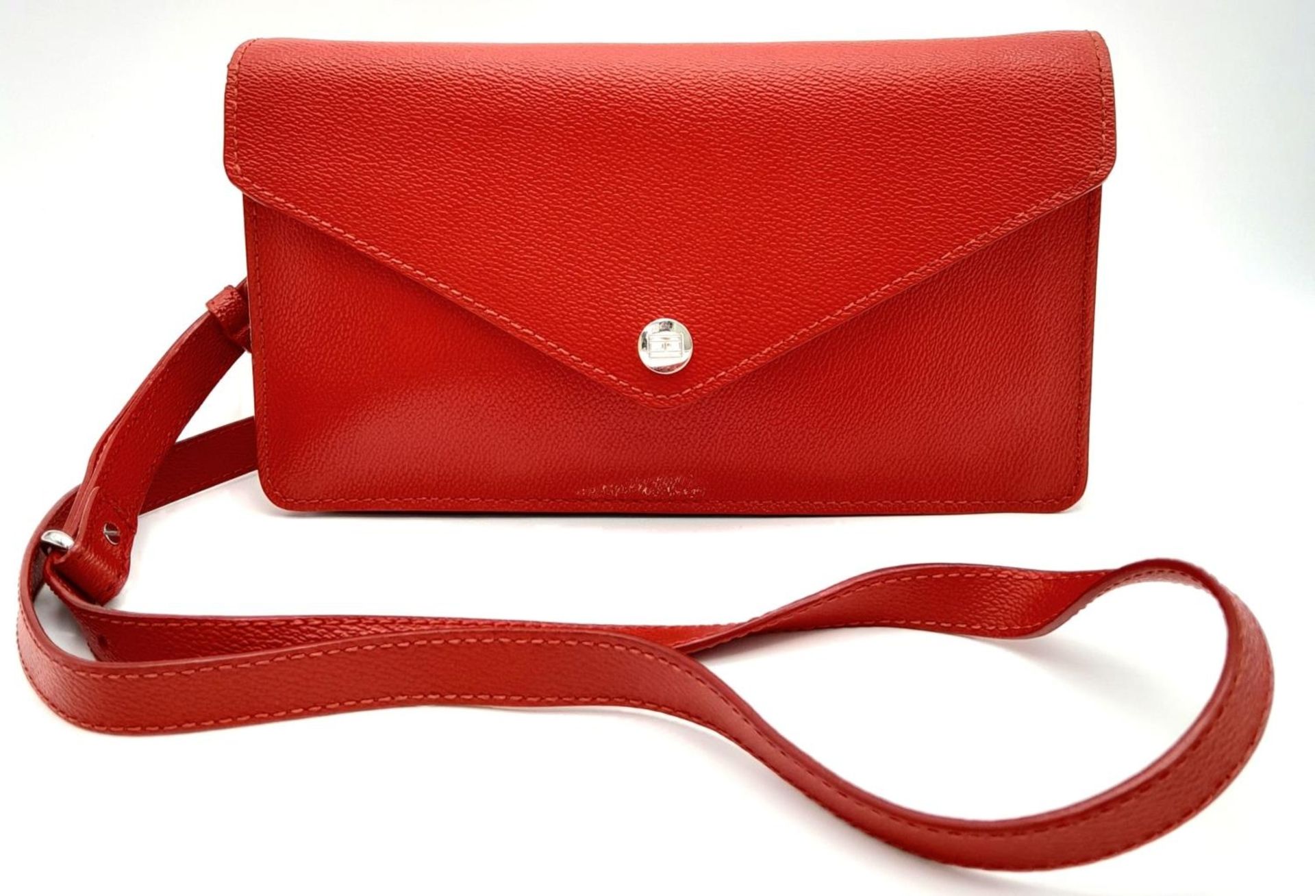 A Tommy Hilfiger Red Wallet Crossbody Bag. Leather exterior with silver-toned hardware, removeable