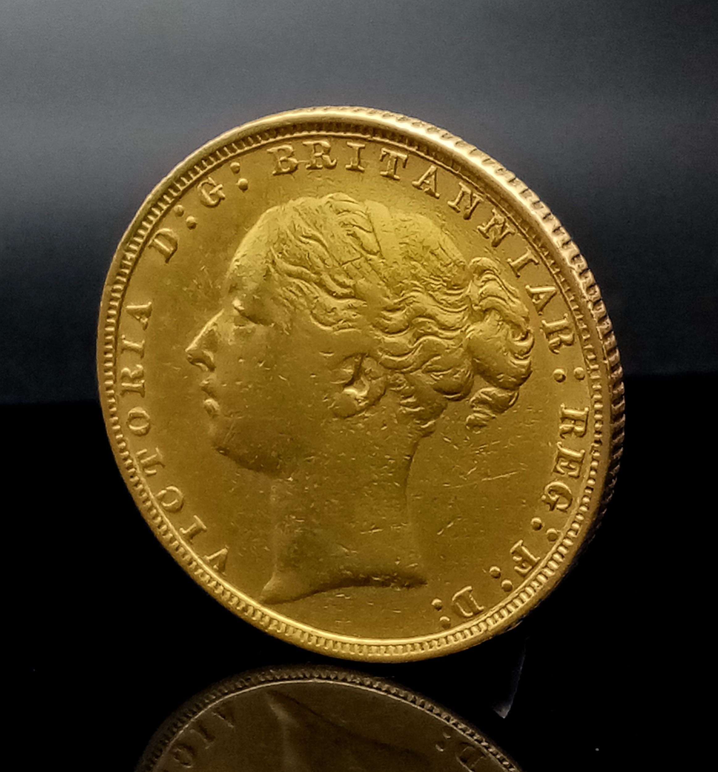 An 1884 Queen Victoria 22K Gold Full Sovereign Coin. Good definition.