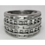 AN 18K WHITE GOLD 5 ROW DIAMOND RING. MIXTURE OF ROUND BRILLIANT CUTS AND BAGUETTE CUT DIAMONDS.