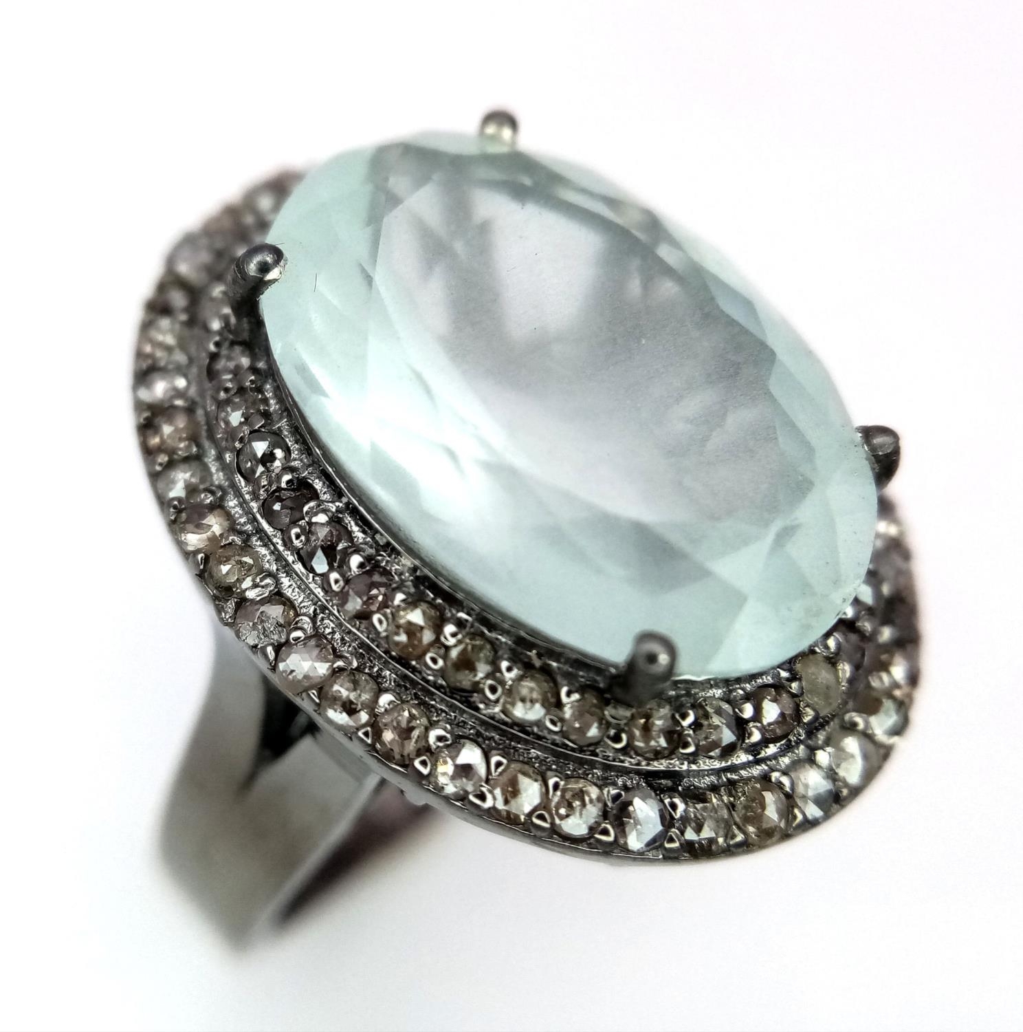 A 7.35ct Aquamarine Gemstone Ring with a 0.90ctw of Diamond Surrounds. Set in 925 Silver. Size N.