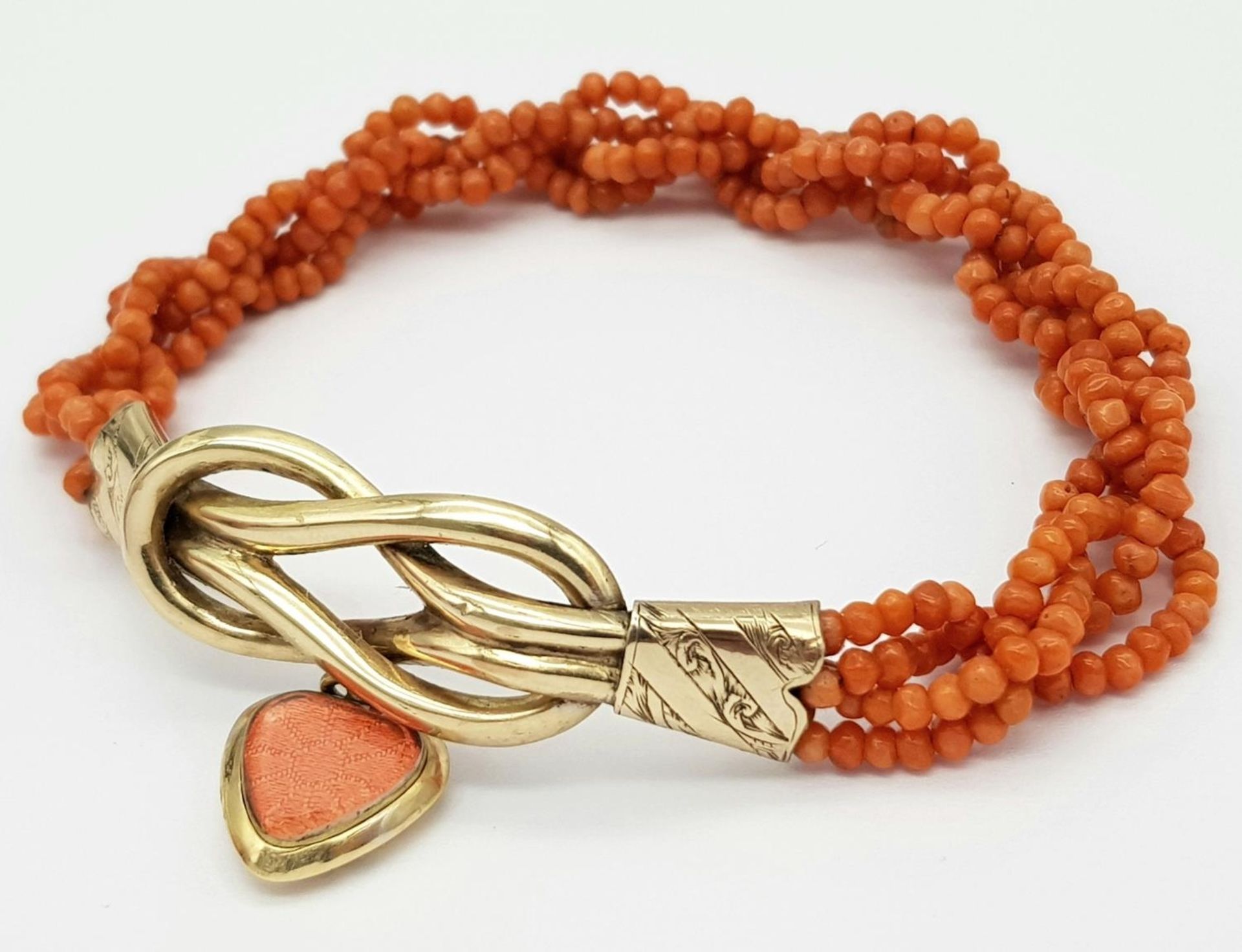 A Vintage 9K Gold and Red Coral Bracelet with Heart Locket. 14g total weight.
