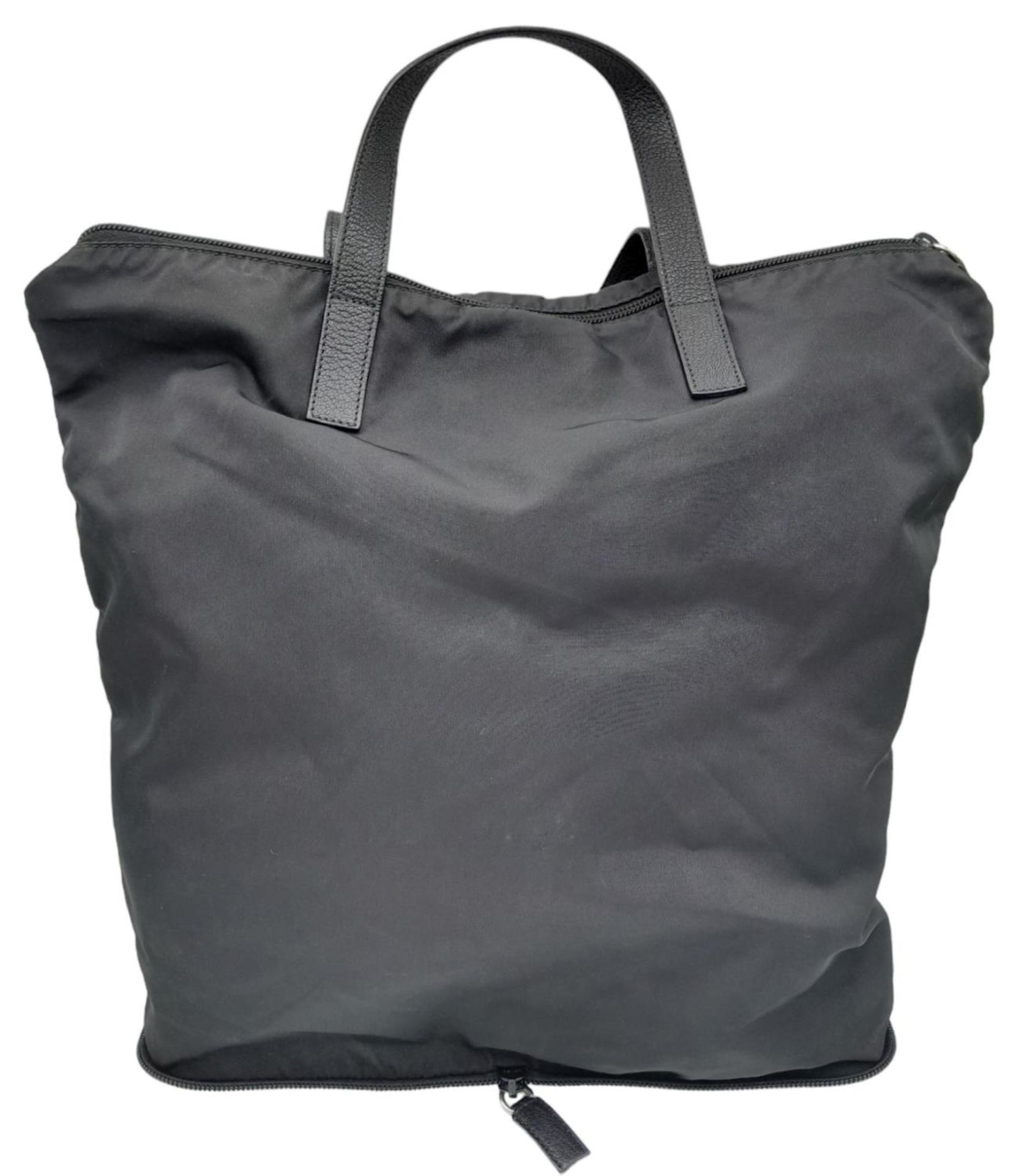 A Prada Black Compactable Tote Bag. Textile exterior with leather handles and zip top closure. Black - Image 2 of 12