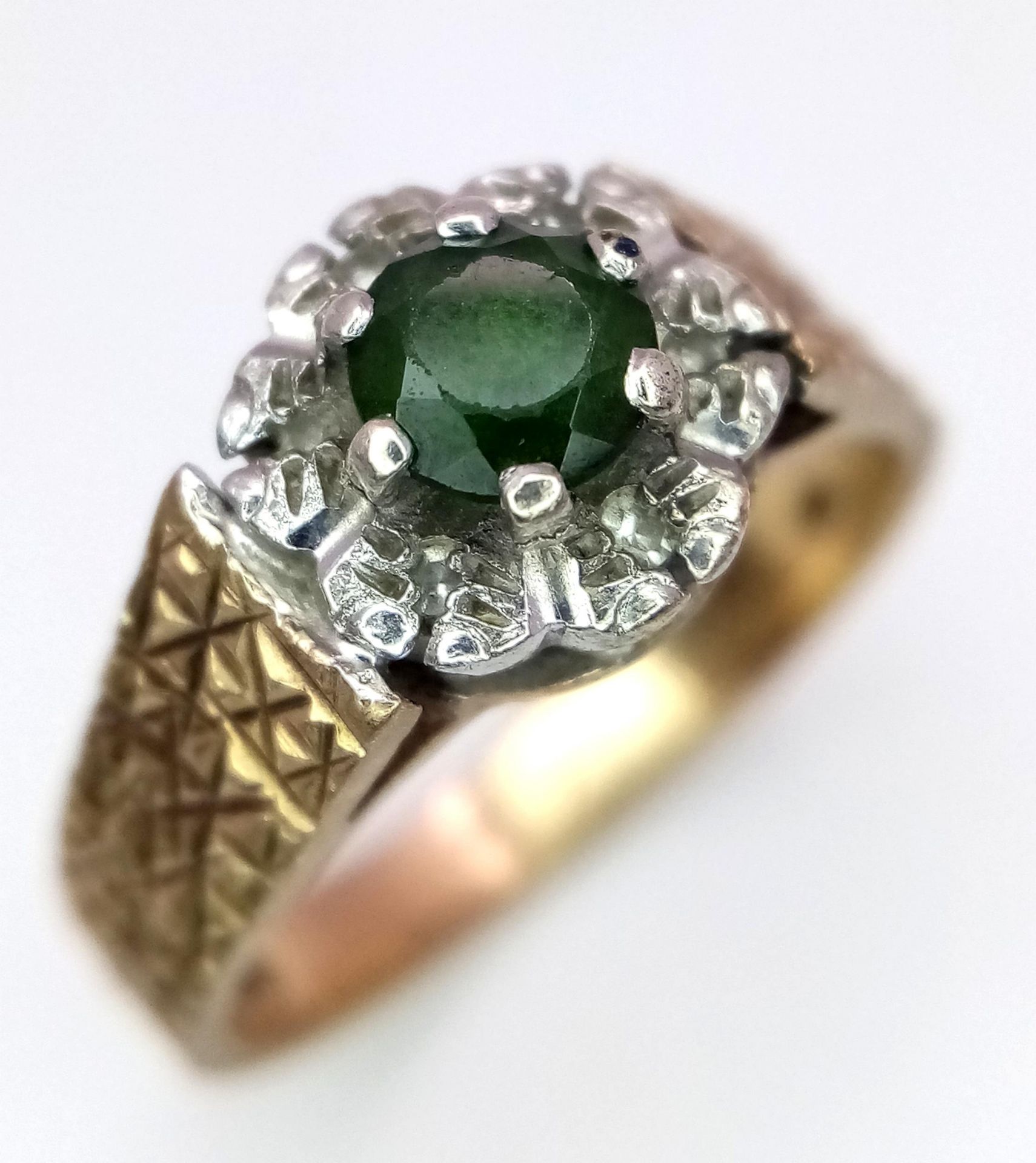 A Vintage 9K Peridot and Diamond Ring. Central round cut peridot with a diamond halo. Size L. 3.4g