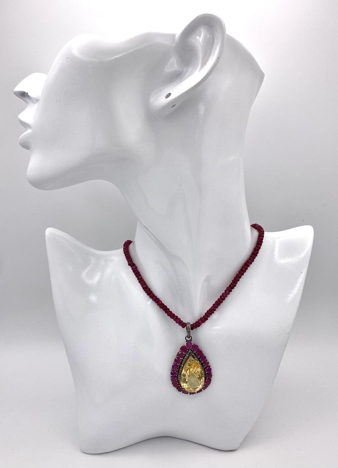 A Citrine and Ruby Pendant with Diamond Surround and Bail - On a Ruby small rondelle necklace with