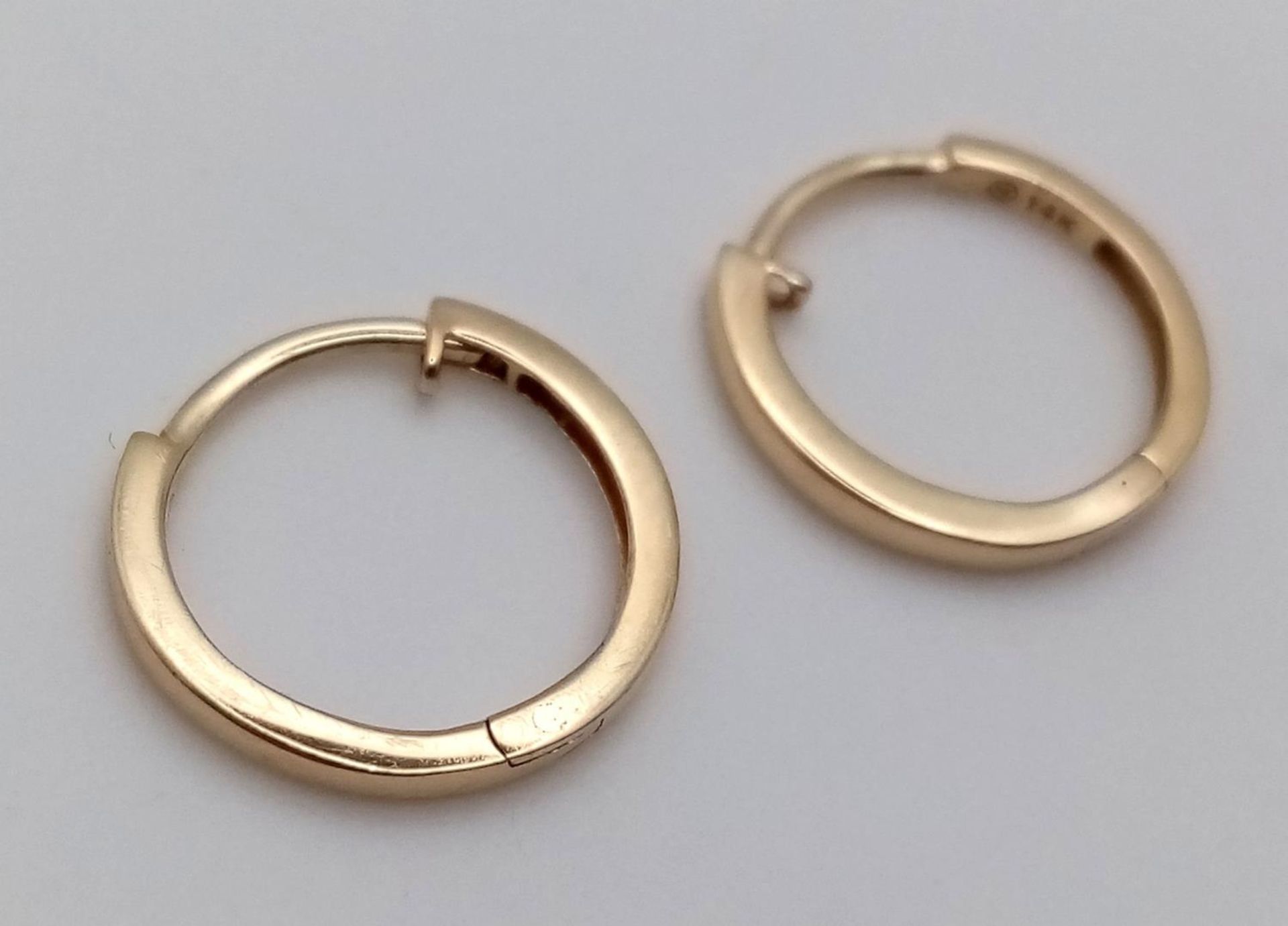 A Pair of Designer Massika 14K Yellow Gold Small Hoop Earrings. 0.8g total weight. - Image 4 of 4