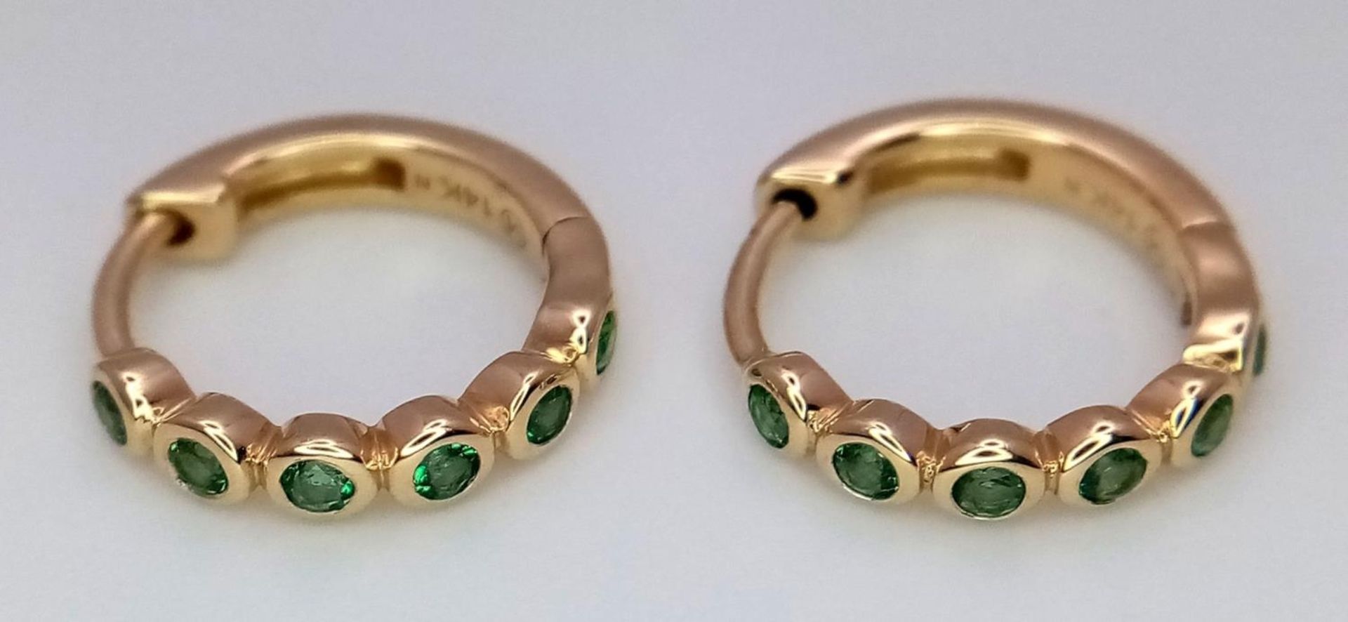 A Pair of Messika 14K Gold Small Emerald Hoop Earrings. 1.7g