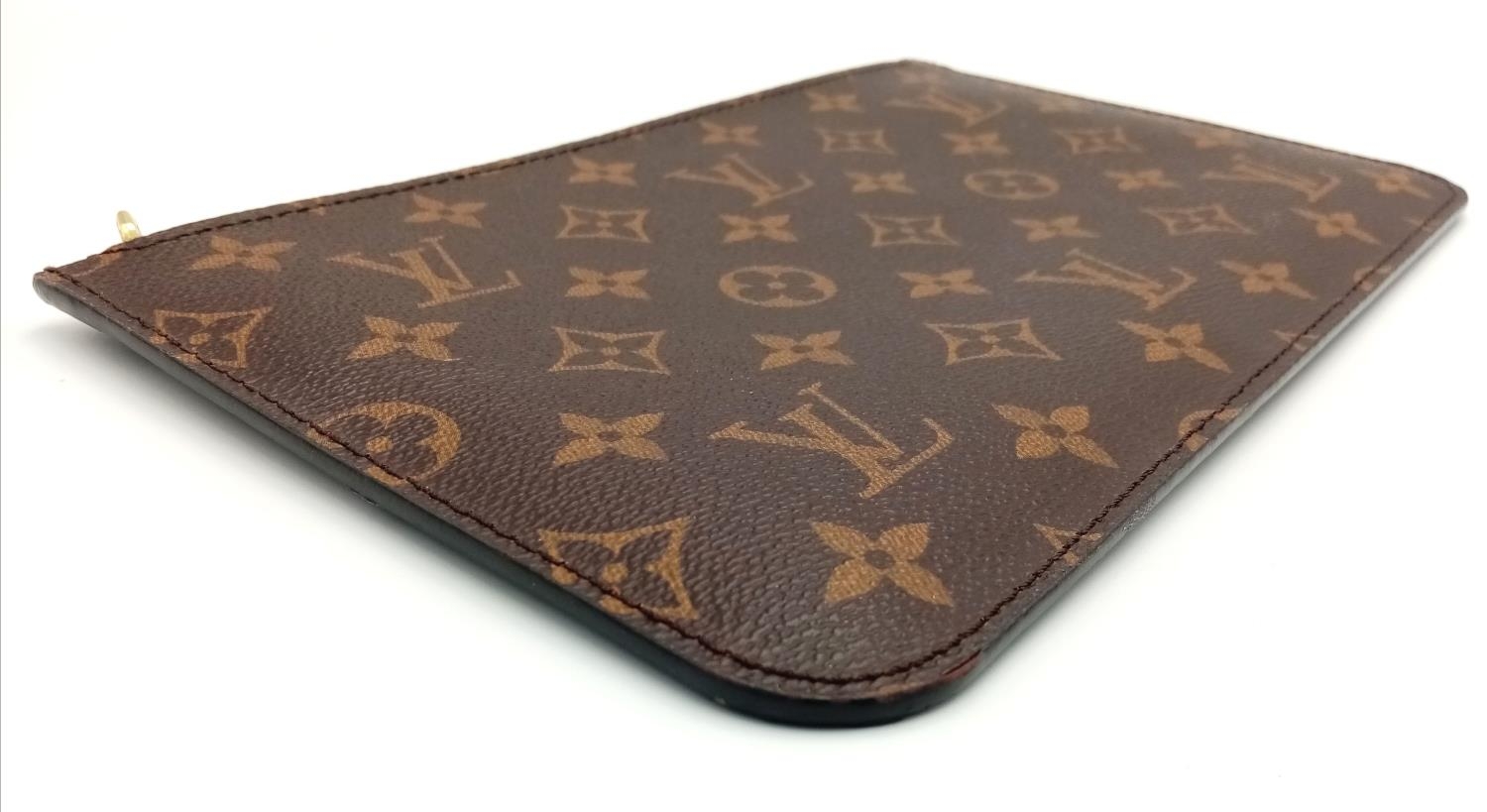 A Louis Vuitton Neverfull Pochette. Monogramed canvas exterior with gold-toned hardware and zip - Image 3 of 7