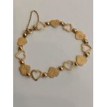 Extremely pretty 9 carat GOLD HEART BRACELET. Complete with gold safety chain. 4.6 grams. 19 cm.