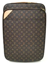 A Louis Vuitton Monogram Pegase Suitcase. Durable leather exterior with gold-toned hardware. Front